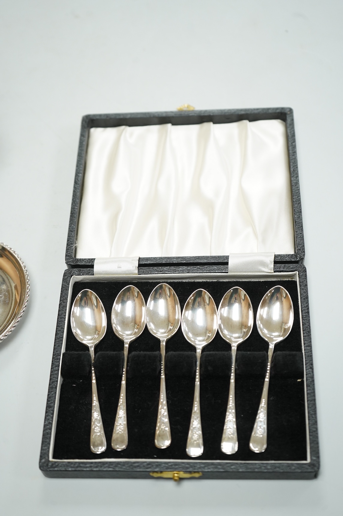 A George V silver sugar caster by Walker & Hall London 1932, 16cm, together with three silver nut dishes and a cased set of six silver coffee spoons.